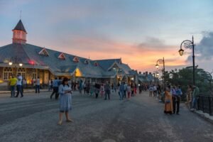 Crowds walking near colonial-style buildings on Shimla Mall Road at sunset