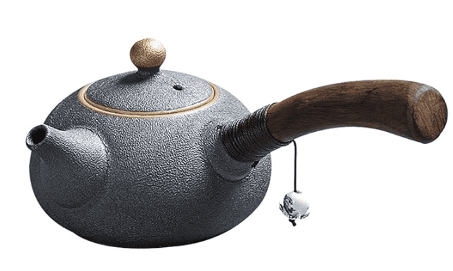 Ceramic teapot with lid and spout used for brewing and serving tea