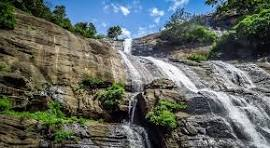 Aerial view of Kutralam waterfalls and surrounding green forest in Tamil Nadu